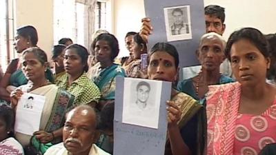 Sri Lankans holding picture of their lost relatives