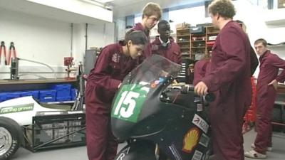 Young engineers work on a motorbike