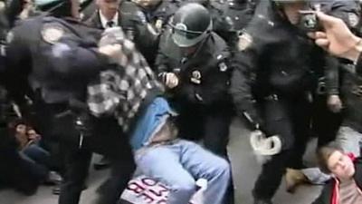 Police carrying protesters away at Occupy New York