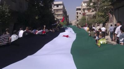 Demonstrators protesting against Syria's President al-Assad