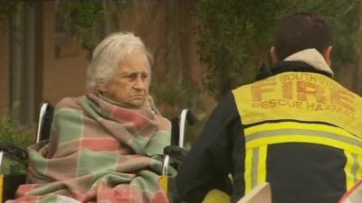 Elderly lady and firefighter