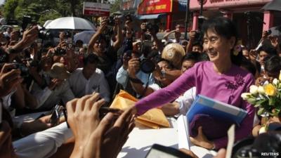 Aung San Suu Kyi greets supporters