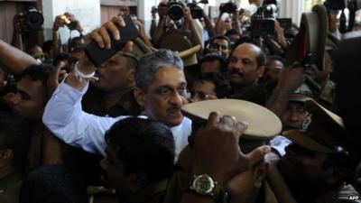 Sarath Fonseka is escorted by police as he arrives at the Colombo High Court in Colombo