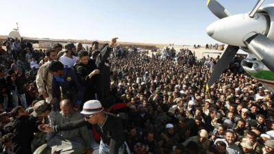 crowd of people gather at Zintan airport to see Saif al-Islam Gaddafi