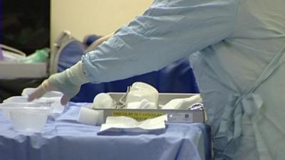 NHS worker working with sterilised medical utensils