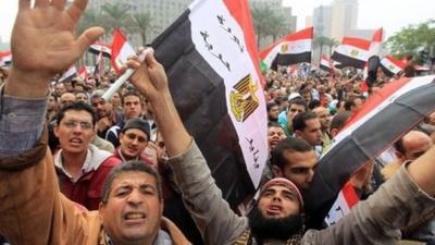 Egyptian protesters wave national flags in Cairo
