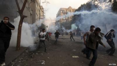 Protesters run from tear gas