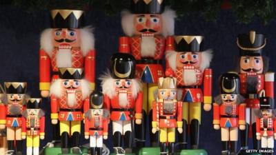 Hand-painted nutcrackers stand among other Christmas ornaments