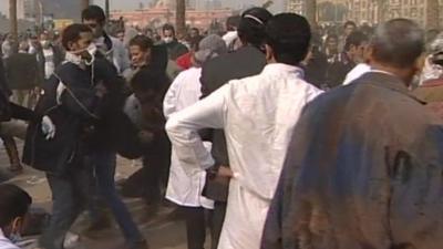 Protesters in Tahrir Square being taken for medical care.