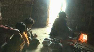 Family sitting on floor in India