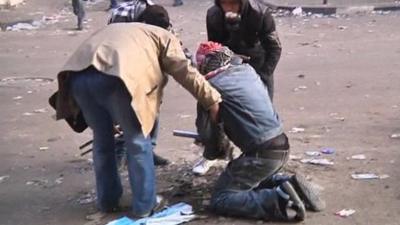 Protesters checking on injured colleague