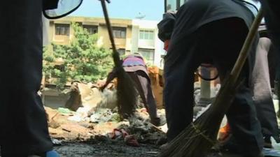 People clean streets in Thailand