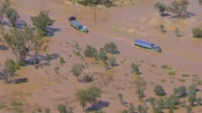 Lorries in a flooded road