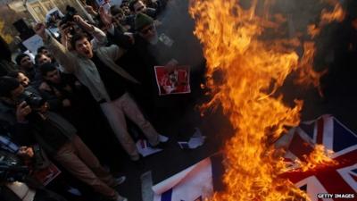 Protesters set fire to the British and Israeli flags outside the British embassy in Tehran