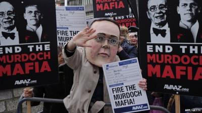 Demonstrators gather outside the Queen Elizabeth II Centre as BSkyB hold their annual general meeting