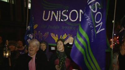 Hospital staff in Bristol hold flags on picket line