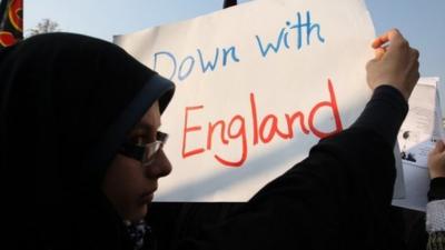 Iranian demonstrators hold 'Down with England' banner