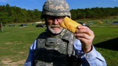 Dr George McGavin holds a sandwich