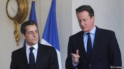 Prime Minister David Cameron (R) speaks to French President Nicolas Sarkozy (L)