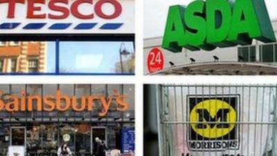 Signage for Tesco, Asda, Sainsbury's and Morrisons