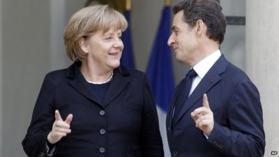 French President Nicolas Sarkozy (R) greets German Chancellor Angela Merkel (L)