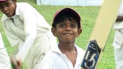 Boy playing cricket