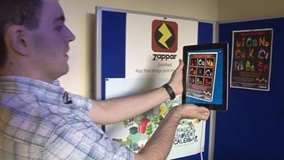 Simon Taylor sets a poster alight using an augmented reality app on his iPad