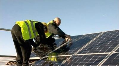 Solar panels being fitted on a roof