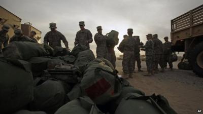 US Army soldiers load their baggage on to lorry