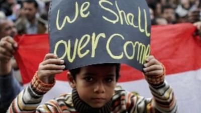 Young boy holding sign