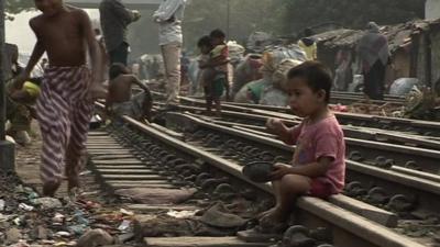 A child eats on a rail track