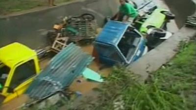 Vehicles left capsized by the floods.