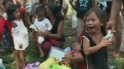 Girl weeps following devastating floods in the Philippines.