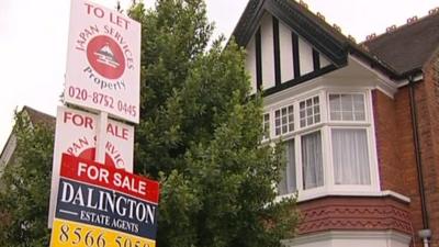 For sale signs in front of house