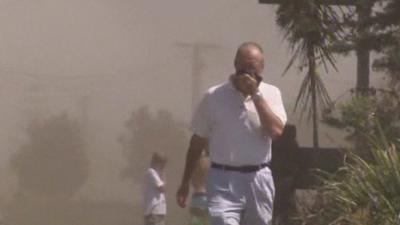 Man protecting his face from dust