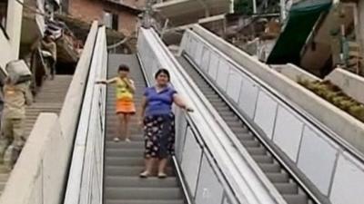 Residents try out the giant outdoor escalator in Medellin