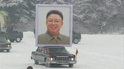 Car carrying picture of Kim Jong-il