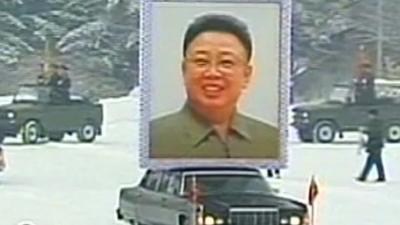 Car carrying picture of Kim Jong-il