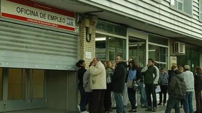 Workers wating outside a job centre in Spain