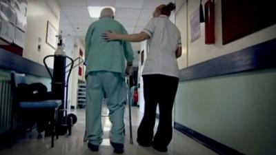 Elderly man being assisted by nurse