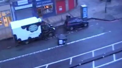 An overturned wheelie bin in the street