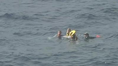 Group floating in sea using ice box