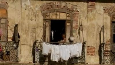 Lady on a balcony in Havana