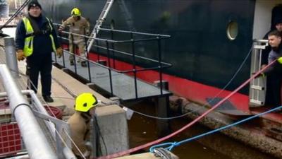 Firemen working at the Royal Yacht Britannia