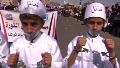 Boys demonstrating with handcuffs and tape