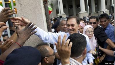 Anwar Ibrahim celebrates with supporters