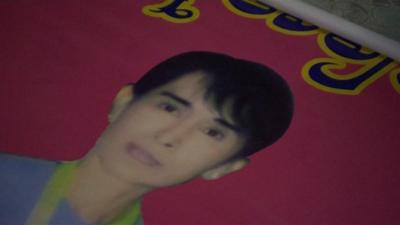 Poster of Aung San Suu Kyi rolled out on the floor