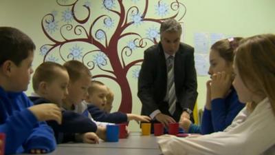 Headteacher and school children