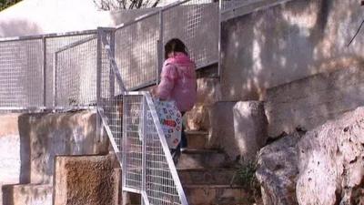 Greek child climbs flight of steps