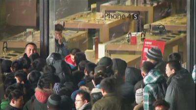 Crowd outside an Apple store in Beijing, where eggs were thrown